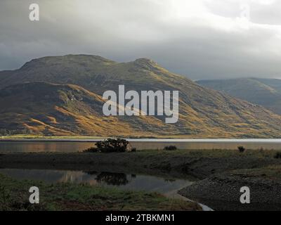 Paesaggio suggestivo con basso sole serale sulle scoscese colline costiere sulla costa dell'Isola di Mull, Scozia, Regno Unito Foto Stock