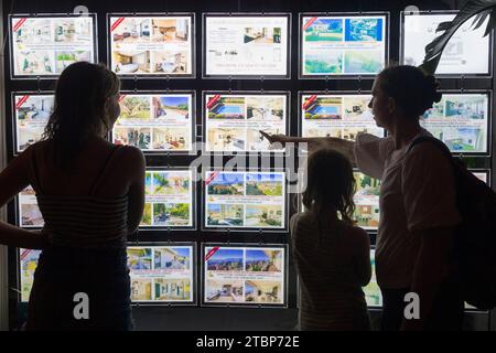 Donna, mamma, visualizzazione finestra agente immobiliare prezzi di casa / case / appartamento / appartamenti e appartamenti in vendita / in affitto / affittare / affittare, come la figlia guarda. Cannes. Francia. (135) Foto Stock