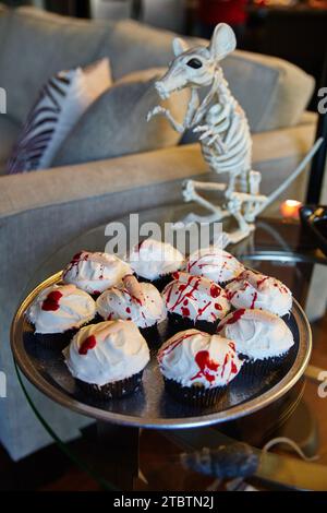 Torte di Halloween con zenzero sanguinato e scheletro roditore in ambientazione da festa Foto Stock