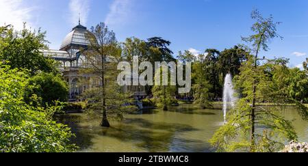 Una foto dell'iconico Palacio de Cristal e del laghetto e degli alberi circostanti presso il Parco El Retiro Foto Stock