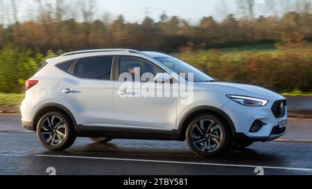 Milton Keynes,Bucks,UK - Dec 8th 2023:  2023 white MG ZS car driving on a wet road, Foto Stock