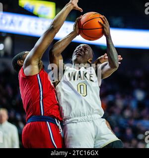 9 dicembre 2023: N.J.I.T Highlanders Guard Sebastian Robinson (0) fouls Wake Forest Demon Deacons Guard Kevin Miller (0) durante la prima metà del match NCAA Basketball Matchup al LJVM Coliseum di Winston-Salem, NC. (Scott Kinser/CSM) Foto Stock