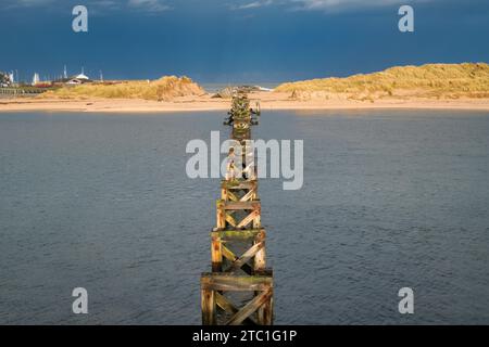 Il vecchio ponte pedonale si erge nel mare nel pomeriggio. Lossiemouth, Morayshire, Scozia Foto Stock