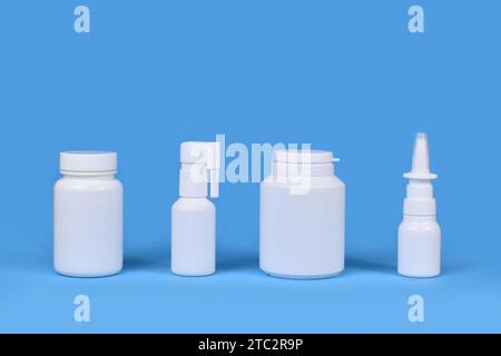 Farmaci per freddo e canna fumaria. Spray nasale, spray alla gola, pillole di fila su sfondo blu Foto Stock