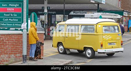 Morrisons Daily Shop e stazione di rifornimento carburante crossover e negozio di cibo da asporto VW Volkswagen camper gialli, camper, camper, camper e cani che aspettano di attraversare Cromer UK Foto Stock