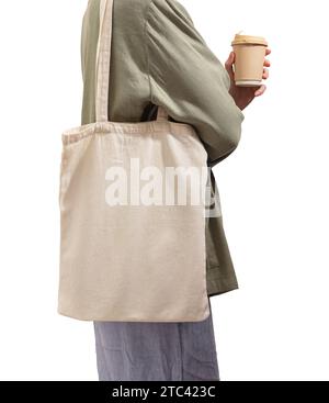 Donna moderna che trasporta una borsa tote ecologica, un acquirente, una tazza di carta in mano, isolata su bianco Foto Stock