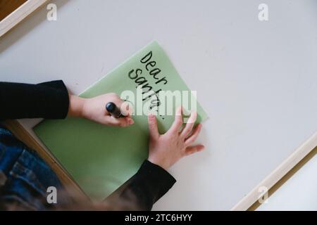 Bambino che scrive una lettera a Babbo Natale Foto Stock