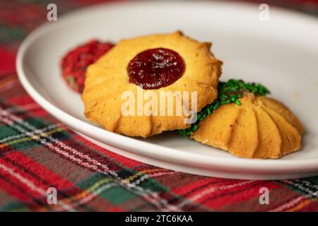 biscotti di natale italiani su un piatto bianco e una tovaglia rossa Foto Stock