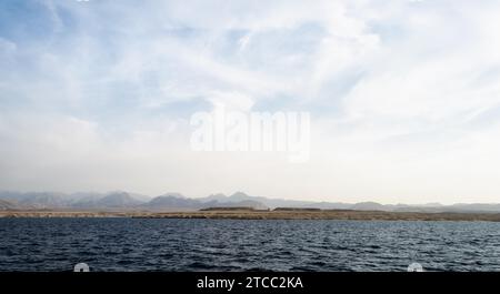 Landscape rocky coast of the Red Sea and blue sky with clouds in Sharm El Sheikh Egypt Stock Photo