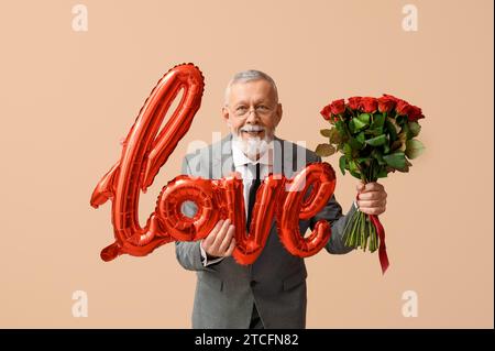 Uomo maturo con bouquet di rose e mongolfiera a forma di AMORE per le parole per San Valentino su sfondo beige Foto Stock