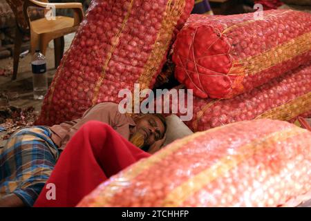 Dhaka, Wari, Bangladesh. 12 dicembre 2023. Il venditore bengalese organizza le cipolle sul mercato all'ingrosso del Kawran Bazar a Dacca, Bangladesh, il 13 dicembre 2023. I prezzi delle cipolle sono quasi raddoppiati dopo che le autorità indiane hanno dichiarato un embargo sulle esportazioni fino al marzo 2024. (Immagine di credito: © Habibur Rahman/ZUMA Press Wire) SOLO USO EDITORIALE! Non per USO commerciale! Foto Stock