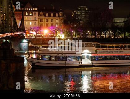 13.12.2023 Francoforte Impressionen auf dem Frankfurter Weihnachtsmarkt am Mainufer auf der Frankfurter Altstadt Seite mit Blick zum Stadtteil Sachsenhausen und einem Ausflugsschiff Johann Wolfgang von Goethe Lichtreflectionen auf der Wasseroberfläche Frankfurt Main Hessen Deutschland **** 13 12 2023 Frankfurt Impressions al mercato di Natale di Francoforte sulle rive del meno, sul lato della città vecchia di Francoforte, con vista del quartiere di Sachsenhausen e di un'escursione in barca Johann Wolfgang von Goethe riflessi luminosi sulla superficie dell'acqua Francoforte sul meno Assia Germania Foto Stock