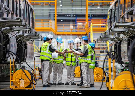 (231214) -- BANGKOK, 14 dicembre 2023 (Xinhua) -- i membri del personale della China Railway Rolling Stock Corp (CRRC) Puzhen Alstom Transportation Systems Limited ispezionano i treni presso il Yellow Line Monorail Maintenance Center di Bangkok, Thailandia, 22 settembre 2023. Prodotta dalla CRRC cinese Puzhen Alstom Transportation Systems Limited e gestita da agenzie tailandesi, la monorotaia "Yellow Line" ha iniziato le operazioni commerciali a luglio. La Pink Line ha iniziato una prova pubblica il 21 novembre. Entrambe le monorotaie sono dotate di treni senza conducente a costi contenuti con costi di costruzione inferiori rispetto alle unità sub convenzionali Foto Stock