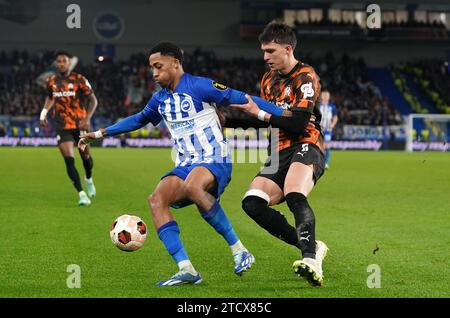 Joao Pedro di Brighton e Hove Albion (a sinistra) e Leonardo Balerdi dell'Olympique Marsiglia si battono per il pallone durante la partita del gruppo B di UEFA Europa League all'American Express Stadium di Brighton. Data immagine: Giovedì 14 dicembre 2023. Foto Stock