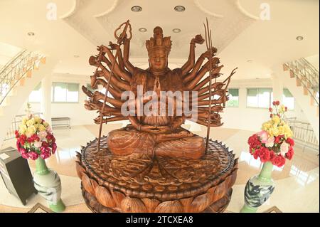 La dea Guanyin è scolpita da un grande pezzo di legno di sandalo profumato. All'interno del Phop Chok ThamaChedi Phra Maha Chedi al tempio Wat Huay Pla Kang. Foto Stock