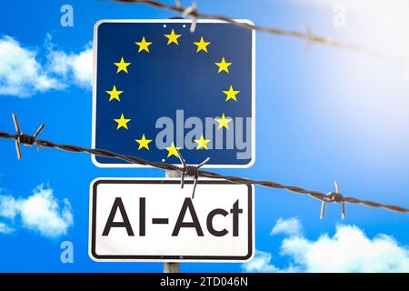 15 dicembre 2023: Firma con bandiera dell'UE dietro una recinzione di filo spinato con l'iscrizione ai-Act FOTOMONTAGE *** Schild mit EU-Flagge hinter einem Stacheldrahtzahn mit der Aufschrift ai-Act FOTOMONTAGE Foto Stock