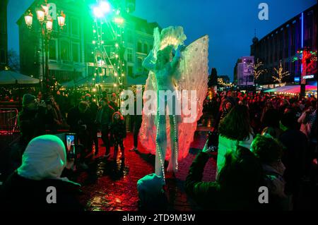 Nijmegen, Gelderland, Paesi Bassi. 16 dicembre 2023. Una donna su palafitte alte e con abiti bianchi è circondata da un pubblico corvo. La stagione natalizia è iniziata a Nijmegen con una bella sfilata invernale composta da un gruppo di artisti acrobatici che camminano su palafitte caratterizzate da creature fantasy. Una volta arrivato a Plein 1944, Erik van Zanten, presidente della "Casa per il centro città", e il consigliere John Brom aprirono le settimane invernali di Nijmegen con l'illuminazione di un albero di Natale alto dieci metri. (Immagine di credito: © Ana Fernandez/SOPA Images via ZUMA Press Wire) SOLO USO EDITORIALE! Non per Foto Stock