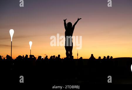 München, Deutschland 17. Dicembre 2023: Fussball, Herren, Bundesliga, Saison 2023/2024, FC Bayern München - VFB Stuttgart, Allianz Arena Die Gerd Müller Statua auf der Esplanade vor der Allianz Arena beim Sonnenuntergang, Dämmerung, Darunter viele Menschen, fans zu sehen DFB, DFL regolamenti vietano qualsiasi uso di fotografie come sequenze di immagini e/o quasi-video Foto Stock