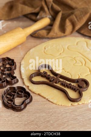 Preparare dolci fatti in casa per cani sani. Impastare con le taglierine per biscotti. Foto Stock