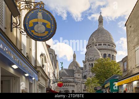 Ammira i negozi lungo Rue du Chevalier de la barre guardando verso le cupole della Basilica del Sacro cuore, Montmartre, Parigi, Francia Foto Stock