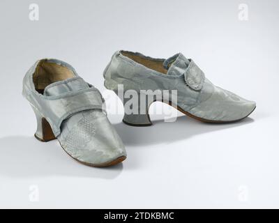Scarpa da donna di Damasco di seta azzurro con due alette sul collo, anonima, c. 1725 - c. 1750 scarpa da donna di Damasco di seta azzurro. Modello: Spitse Wijzing Nose, una copertina e due lamiere laterali. Sulle cuciture, che tengono insieme i caricatori, uno pneumatico si strappa lateralmente. Linguetta quadrata sul collo del piede. Due alette scorrono sulla linguetta dalle lamiere laterali. L'aletta destra è dotata di un gancio in ferro che può essere agganciato a un anello sull'aletta sinistra. La parte anteriore del tallone scorre leggermente verso il basso con un angolo arrotondato rispetto al gufo giallastro. Il lato e la parte posteriore del tallone sono leggermente sartoriali e ricoperti di seta azzurra .. Bianco S Foto Stock