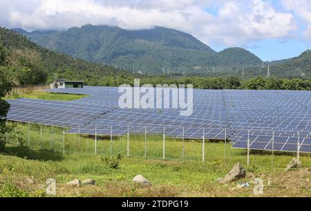 Alaminos, Filippine. 19 dicembre 2023: La centrale solare Alaminos AC Energy Storage (ACEN), uno dei più grandi progetti fotovoltaici/agrivoltaici del paese. Ieri, durante la riunione della Comunità asiatica a emissioni zero (AZEC) a Tokyo, Pres. Marcos ha incitato gli investimenti dell'ASEAN nelle energie rinnovabili, promuovendo incentivi fiscali e l'abolizione dei limiti di proprietà estera. Le Filippine cercano di aumentare la quota di energia sostenibile nella sua generazione di energia al 50% nel 2040. Le Filippine sono il quarto mercato emergente più attraente a livello globale per gli investimenti in energie pulite (BloombergNEF). Crediti: Kevin Izorce/Alamy Live News Foto Stock