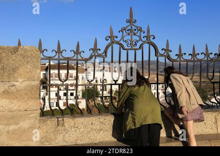 Ronda, Malaga, Spagna - 21 ottobre 2023: I turisti godono della splendida vista panoramica della città di Ronda attraverso la ringhiera del ponte Puente Nuevo a Malaga Foto Stock