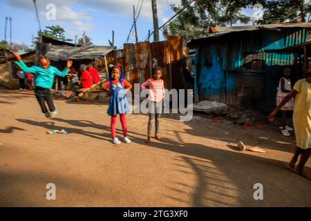 Bambini che giocano fuori dalle strade a Kibera Slum, Nairobi. Una visione attraverso la vita quotidiana a Kibera attualmente la più grande baraccopoli africana e il giorno per da Foto Stock