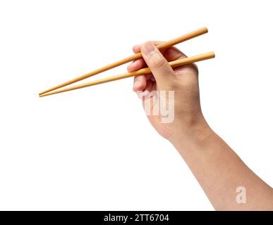 Bacchette in legno isolate a mano su sfondo bianco. Foto Stock