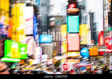 Irriconoscibile Times Square sfocata con veicoli e varie persone sulle strade trafficate della città nel quartiere di New York di edifici moderni di giorno Foto Stock