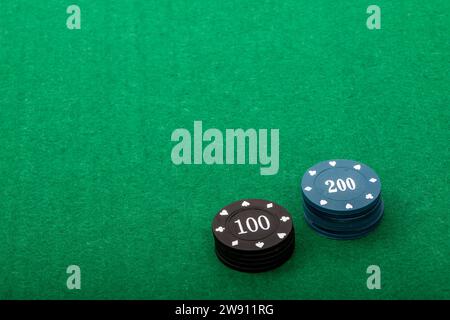 Pile di chip da poker su Green Felt Table, sfondo per le notti di gioco Foto Stock