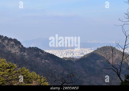 Vista panoramica delle aree urbane di Seoul, vista dalle cime delle montagne sui sentieri escursionistici del Parco Nazionale di Bukhansan Foto Stock