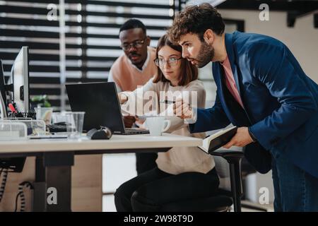 Diverse strategie dei team aziendali in un ufficio moderno, analizzando i dati e discutendo di ricerche di mercato per il successo e la crescita. Foto Stock