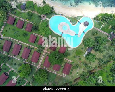 Vista aerea su una piscina a forma di cuore e bungalow sull'isola di Ilheu das Rolas, Sao Tomé e Principe, Africa Foto Stock