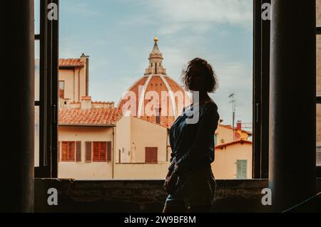 Affascinante donna si trova nel Palazzo Vecchio sullo sfondo della basilica. Turismo e viaggi. Supporti misti Foto Stock