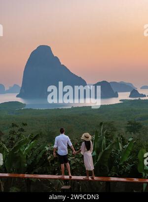 Un paio di uomini e donne che guardano l'alba al punto panoramico di Sametnangshe nella Baia di Phangnga con la foresta di mangrovie nel Mare delle Andamane, la montagna di Sametnangshe Phangnga, Thailandia Foto Stock