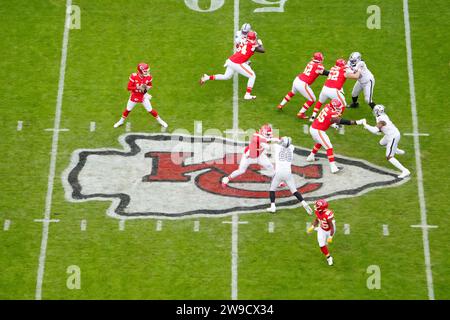 Una visione generale del quarterback dei Kansas City Chiefs Patrick Mahomes (15) prende lo scatto alla linea di scrimmage sul logo dei Chiefs a centrocampo contro i Las Vegas Raiders contro i Las Vegas Raiders durante una partita di football NFL, lunedì 25 dicembre 2023, a Kansas City, Mo. I Raiders sconfissero i Chiefs 20-14. Foto Stock
