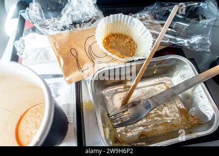 Didascalia 76/150 vassoio per alimenti dell'aeroplano Pranzo finito, contenitori sporchi dopo il pasto, serviti su un sedile in aereo durante il volo Foto Stock