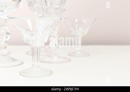 Bicchieri di cristallo di fronte allo sfondo beige. Composizione minima. Foto Stock