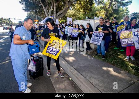 Alla ricerca di un nuovo contratto di lavoro, i dipendenti di assistenza sanitaria multirazziale marciano in segno di protesta durante uno sciopero in una struttura HMO Kaiser permanente a Irvine, C. Foto Stock