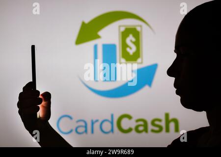 Brasile. 29 dicembre 2023. In questa foto, la silhouette di una donna contiene uno smartphone con il logo CardCash sullo sfondo. (Foto di Rafael Henrique/SOPA Images/Sipa USA) **** esclusivamente a scopo editoriale *** credito: SIPA USA/Alamy Live News Foto Stock