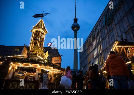 Menschen besuchen den Weihnachtsmarkt am Alexanderplatz a Berlino am 23. Dezember 2023. Weihnachstmärkte a Berlino *** le persone visitano il mercatino di Natale ad Alexanderplatz a Berlino il 23 dicembre 2023 i mercatini di Natale a Berlino Foto Stock