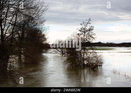 Il fiume Lippe ha fatto irruzione sulle sue sponde. L'acqua alta ha inondato un campo. Le nuvole si riflettono nell'acqua. Foto Stock