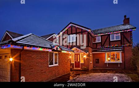 Casa con luci natalizie e neve. Foto Stock