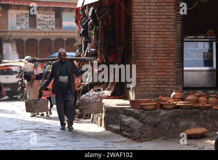 Kathmandu, Nepal - 20 novembre 2023: I lavoratori stanno collocando il vasaio. potter si trova sotto il sole nella talako Tole o nella cosiddetta piazza della ceramica. Foto Stock