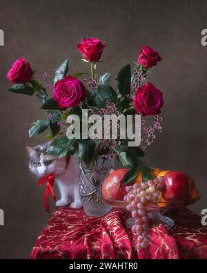 Natura morta con bouquet di rose e frutta e gattino curioso Foto Stock