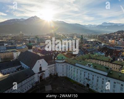 Innsbruck di sera, spettacolo aereo del drone di uno splendido skyline invernale della città, circondato dalle montagne delle Alpi in Austria Foto Stock