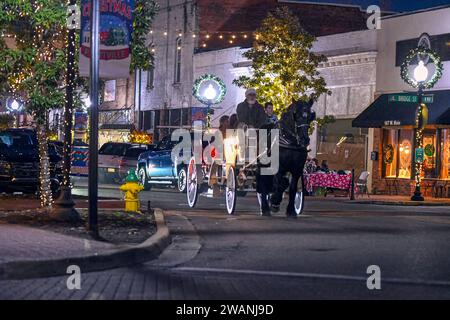 Prattville, Alabama, USA-dic. 12.2023: La carrozza trainata da cavalli porta i visitatori a fare delle passeggiate gratuite nel centro città per l'evento natalizio Main Stree a Prattvil Foto Stock