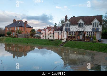 Cookham, Regno Unito. 6 gennaio 2024. Acqua piovana all'esterno del Crown Pub di Cookham. La strada principale che attraversa il villaggio di Cookham nel Berkshire è stata chiusa a causa delle inondazioni dal Tamigi. L'acqua piovana si è riversata nel Cookham Moor, un luogo popolare ogni estate per il concerto pop Let's Rock the Moor. Credito: Maureen McLean/Alamy Live News Foto Stock