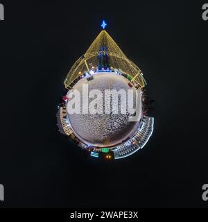 Anno nuovo piccolo pianeta con albero di Natale. Antenna sferica vista notturna panoramica a 360° sulla piazza festosa con illuminazione sotto forma di tenda Foto Stock
